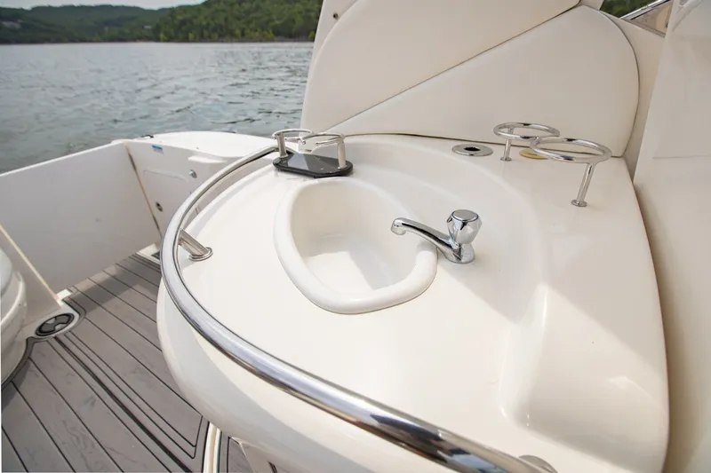 Slide: The Image of 2004 Sea Ray 340 Sundancer boat sink and cup holders on deck. - 20