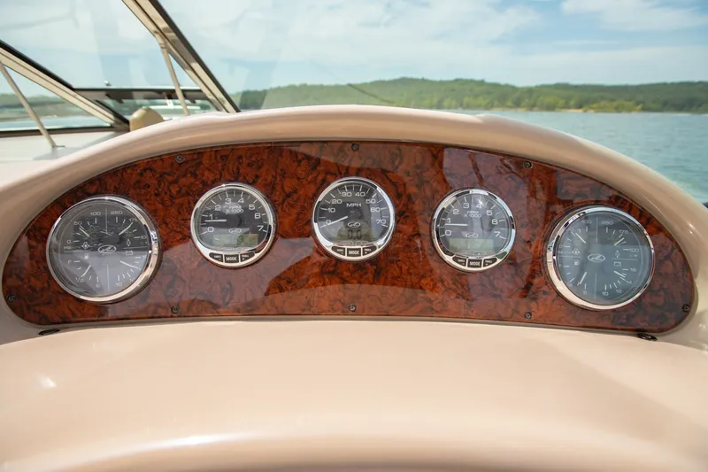 Slide: The Image of Dashboard of 2004 Sea Ray 340 Sundancer boat with wood paneling and gauges. - 29