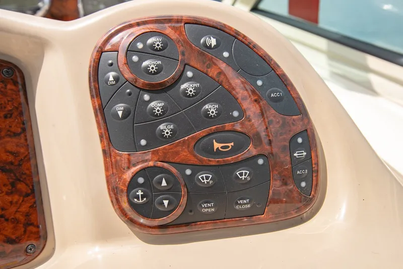 Slide: The Image of Control panel of a 2004 Sea Ray 340 Sundancer boat with various function buttons. - 26