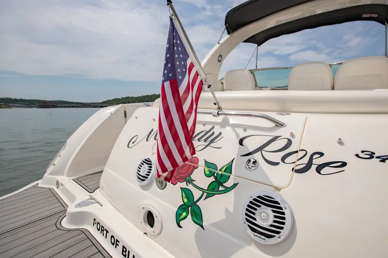 Slide: The Image of 2004 Sea Ray 340 Sundancer boat with American flag and "Lady Rose" name on stern. - 15