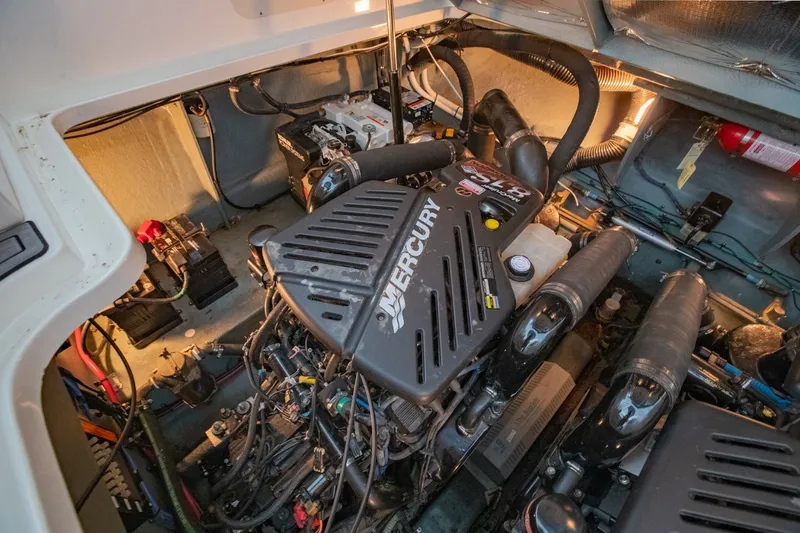 Slide: The Image of Engine compartment of a 2004 Sea Ray 340 Sundancer with Mercury engine components. - 44