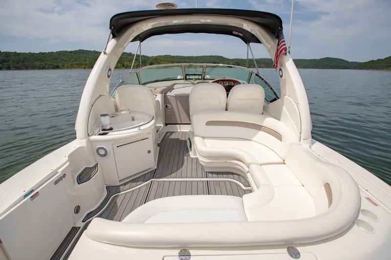 Slide: The Image of 2004 Sea Ray 340 Sundancer boat interior with white seating and lake view. - 16