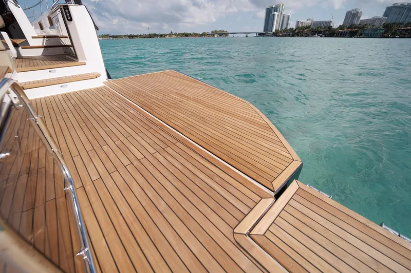 Slide: The Image of Luxurious Hanover 447 yacht deck, 2026 model, overlooking turquoise waters and city skyline. - 42