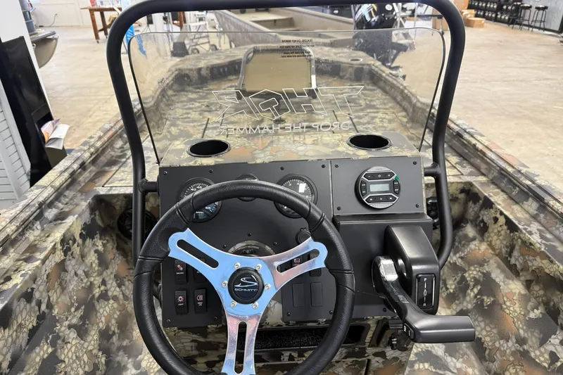Slide: The Image of 2027 Thor BH1900CC boat dashboard with camouflage design and modern steering wheel. - 6
