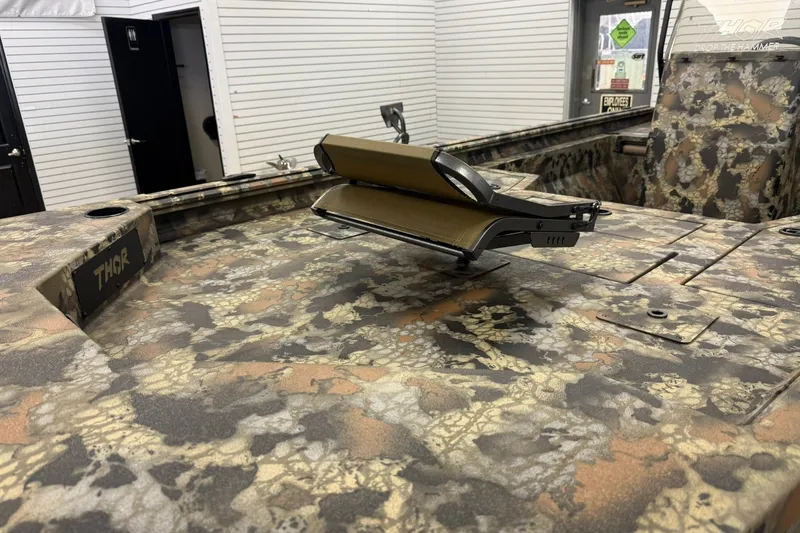 Slide: The Image of Camouflage-patterned Thor BH1900CC boat interior, 2027 model, featuring a mounted accessory. - 17