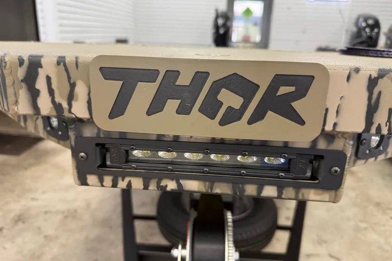 Slide: The Image of Close-up of 2027 Thor BH1900CC boat with camouflage design and LED lights. - 18