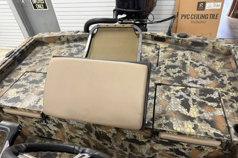 Slide: The Image of Camouflage-patterned Thor BH1900CC boat interior, 2027 model, with beige seating and storage compartments. - 11