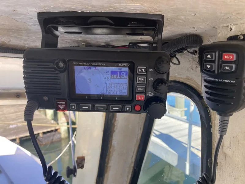 Slide: The Image of A radio with a screen and microphone inside a boat. - 7