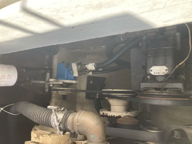 Slide: The Image of View of the engine room of a 1986 BHM 32 boat with various mechanical components. - 15