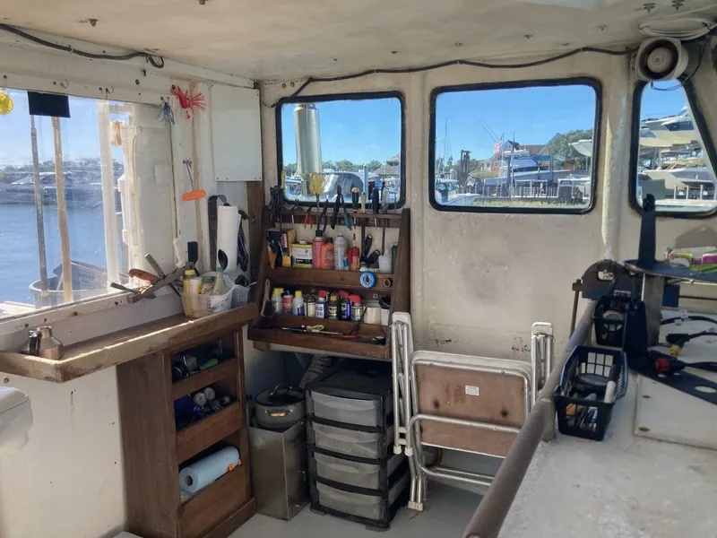 Slide: The Image of Interior of a 1986 BHM 32 boat with shelves full of tools and accessories. - 23