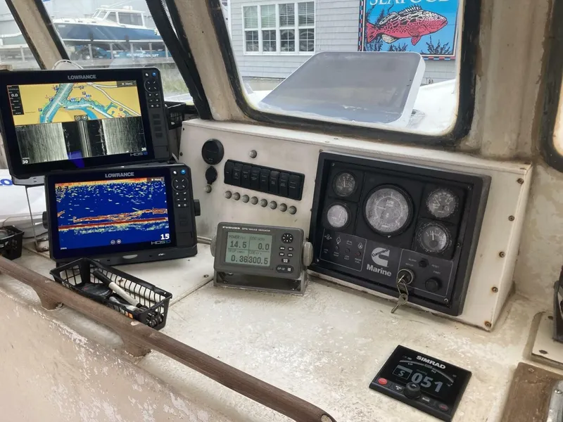 Slide: The Image of The image shows a boat's cockpit with multiple navigation and control devices. - 35