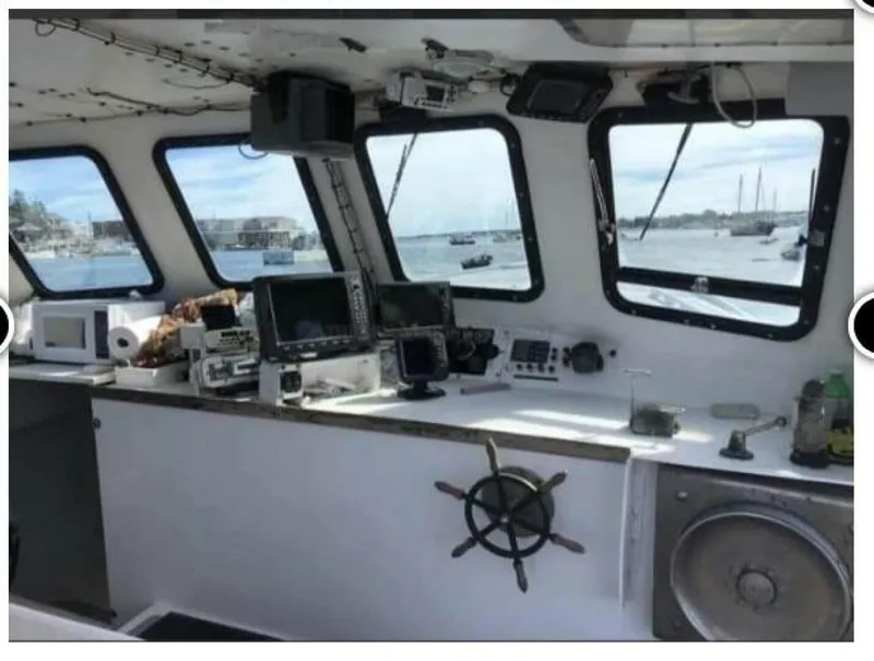 Slide: The Image of The image shows the helm of a 1986 BHM 32 boat with navigation equipment and windows. - 6