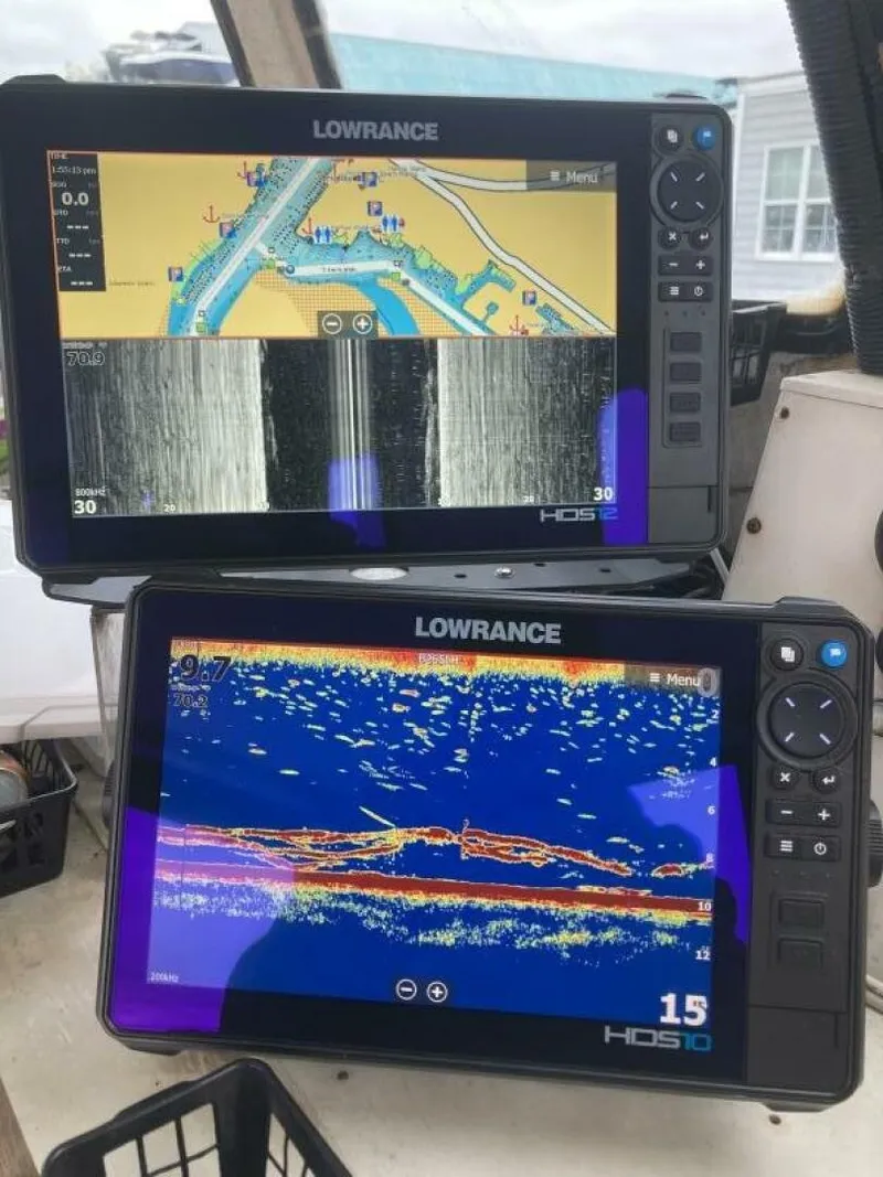 Slide: The Image of Two Lowrance HDS screens display navigation and sonar data on a boat. - 29