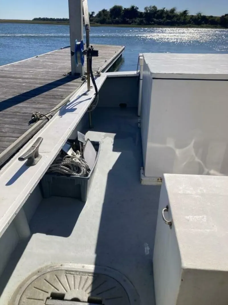 Slide: The Image of The image shows the deck of a 1986 BHM 32 boat docked at a pier. - 11