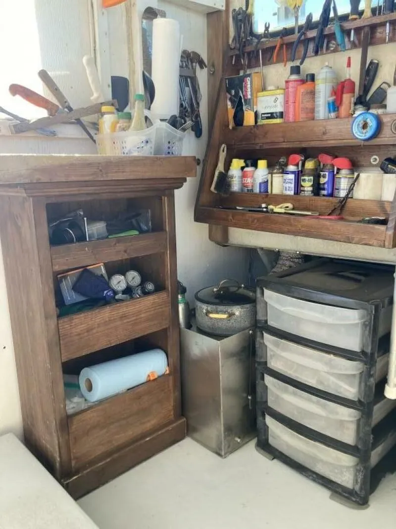 Slide: The Image of Tool and storage area on a boat with shelves and drawers. - 21