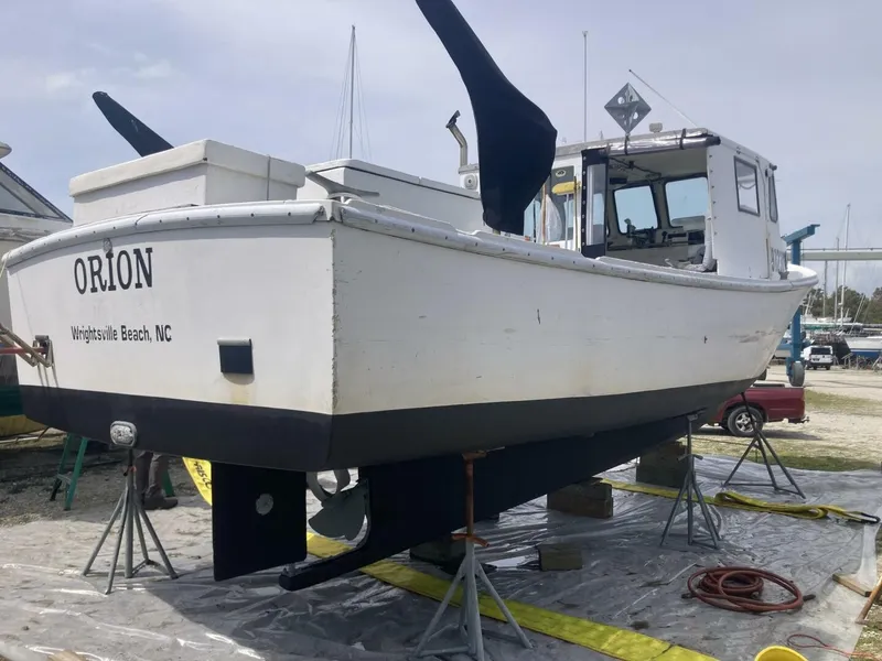 Slide: The Image of A 1986 BHM 32 boat is on stands. It is being serviced in Wrightsville Beach, NC. - 2