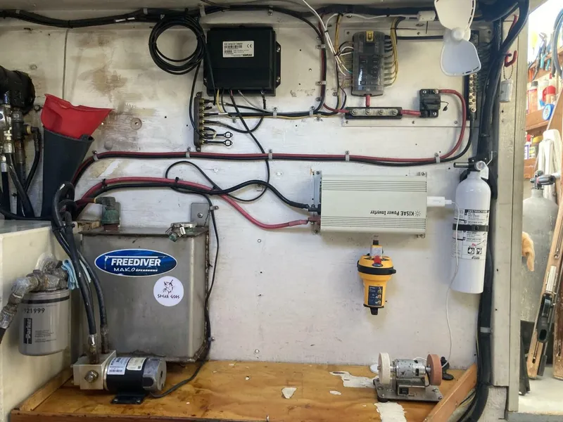 Slide: The Image of Electronics and equipment in a boat's engine room, including wiring, fire extinguisher, and filter. - 20