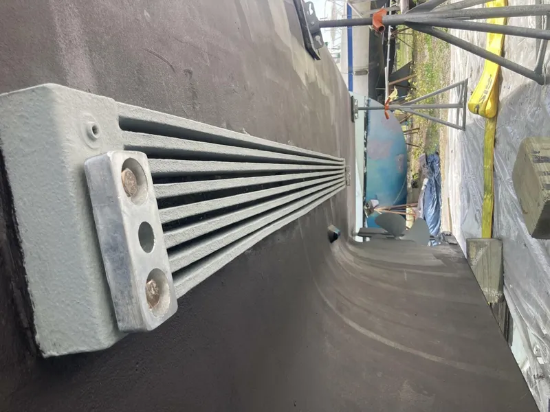 Slide: The Image of Close-up of a 1986 BHM 32 boat hull in a dry dock setting. - 39