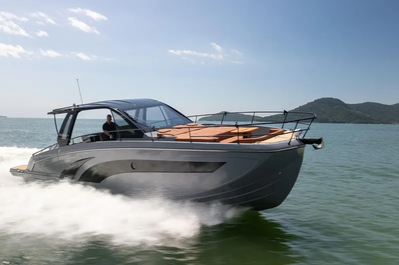 Slide: The Image of Modern Hanover 447 yacht cruising on open water, 2026 model, with scenic mountain backdrop. - 0