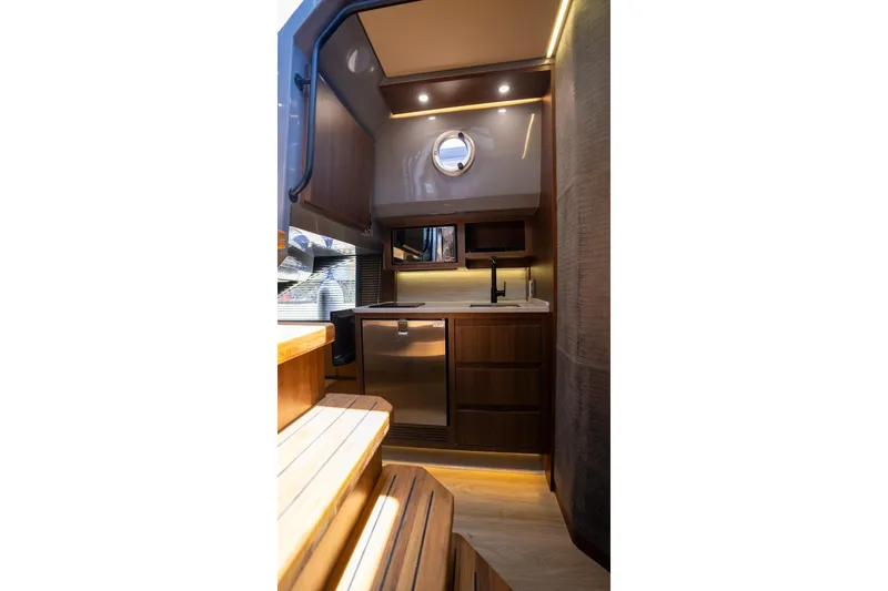 Slide: The Image of Luxurious interior of 2026 Hanover 447 yacht with modern kitchen and wooden finishes. - 19