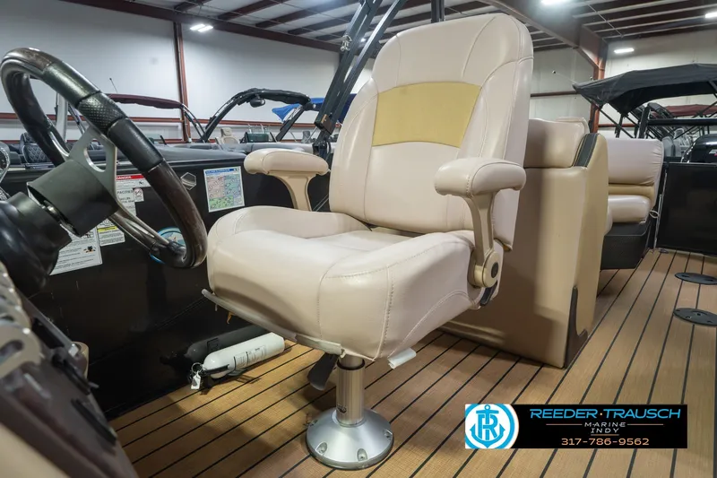 Slide: The Image of Captain's chair in 2017 South Bay 725 RS pontoon boat, showcased indoors. - 43