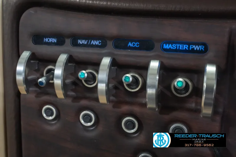 Slide: The Image of Control panel of a 2017 South Bay 725 RS boat with labeled switches. - 38