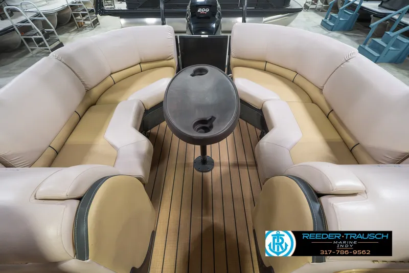 Slide: The Image of 2017 South Bay 725 RS pontoon boat interior with beige seating and wooden flooring. - 21