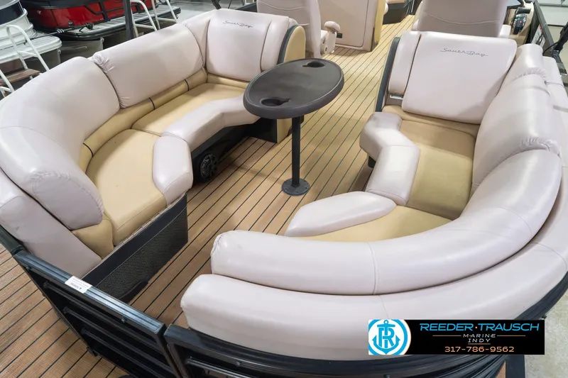 Slide: The Image of 2017 South Bay 725 RS pontoon boat interior with plush seating and table. - 16