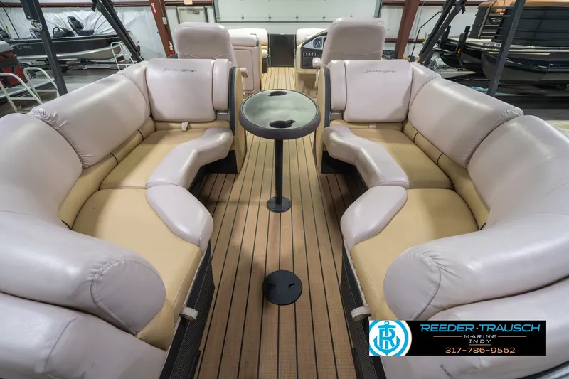 Slide: The Image of Luxurious 2017 South Bay 725 RS pontoon boat interior with plush seating and table. - 22