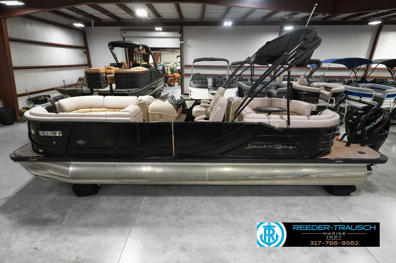 The Image of 2017 South Bay 725 RS pontoon boat in showroom, featuring plush seating and sleek design. - 0