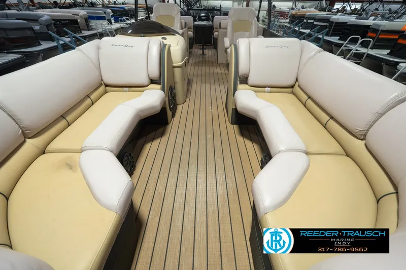 Slide: The Image of 2017 South Bay 725 RS pontoon boat interior with beige seating and wood-style flooring. - 18