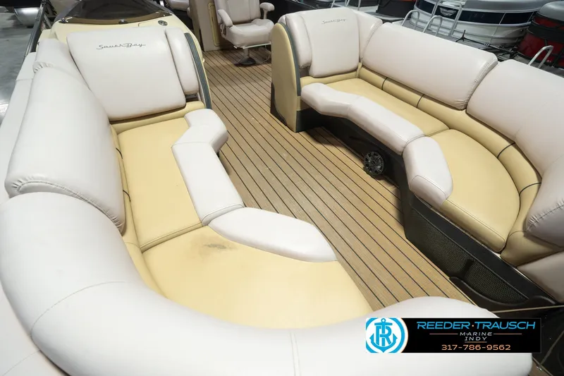 Slide: The Image of 2017 South Bay 725 RS boat interior with beige seating and wood-style flooring. - 14