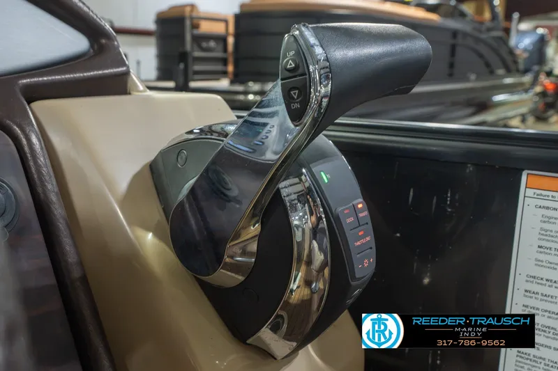 Slide: The Image of Close-up of 2017 South Bay 725 RS boat throttle control in a showroom setting. - 42