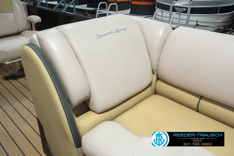 Slide: The Image of 2017 South Bay 725 RS boat seating with beige upholstery and logo, displayed at Reeder-Trausch Marine. - 28