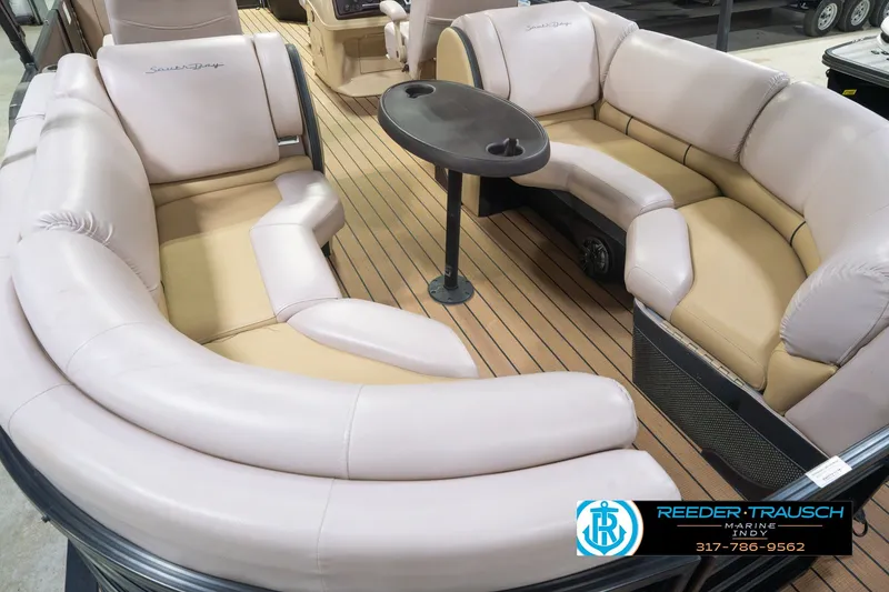 Slide: The Image of 2017 South Bay 725 RS pontoon boat interior with plush seating and table. - 17