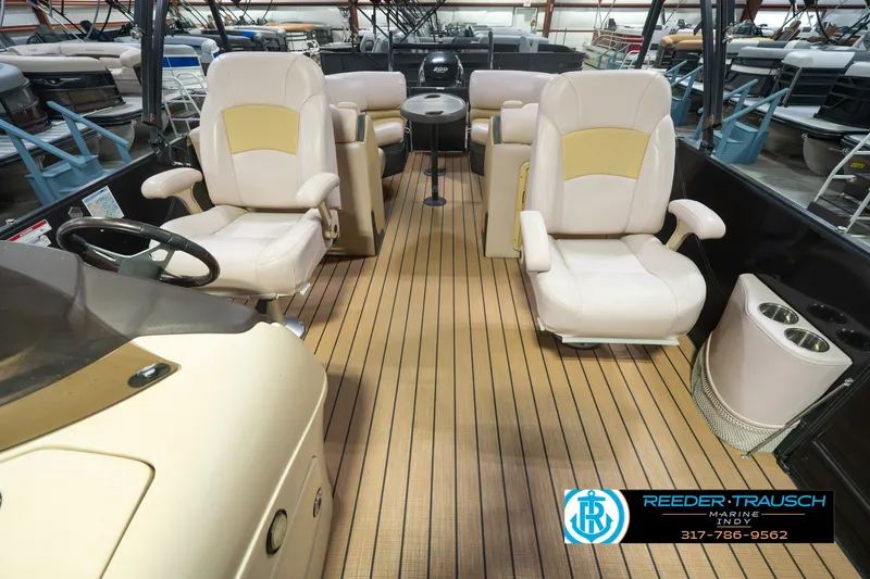 Slide: The Image of Interior of a 2017 South Bay 725 RS boat with beige seating and wood flooring. - 20