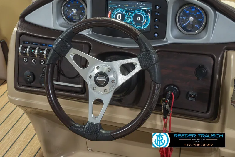 Slide: The Image of Steering wheel and dashboard of 2017 South Bay 725 RS boat with control panel. - 35