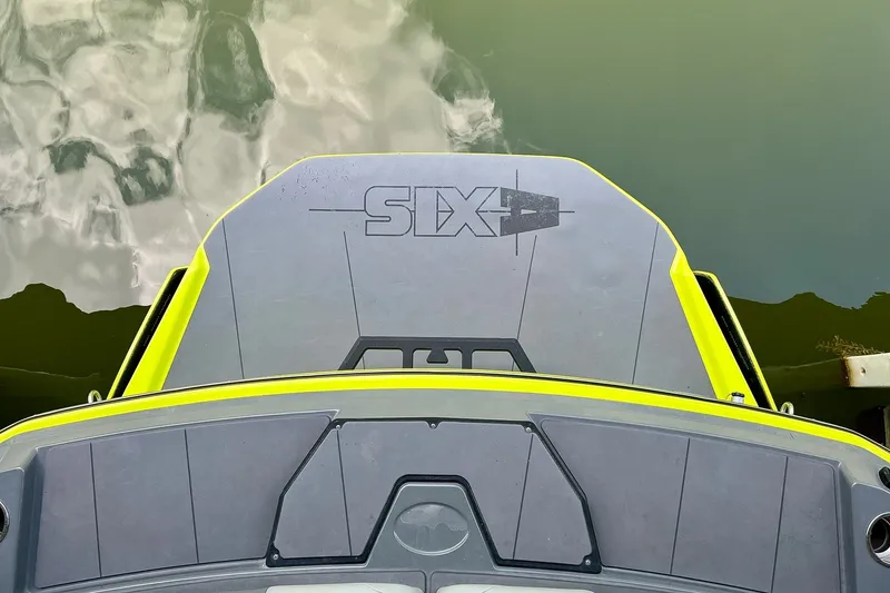 Slide: The Image of 2023 Axis A225 boat swim platform with "SIX" logo, docked on calm water. - 7