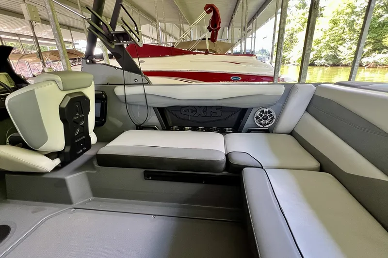 Slide: The Image of 2023 Axis A225 boat interior with gray seating and speaker system. - 11