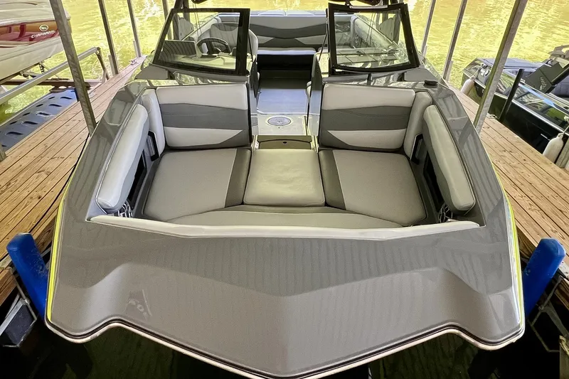 Slide: The Image of 2023 Axis A225 boat with sleek gray seating and modern design in docked position. - 6