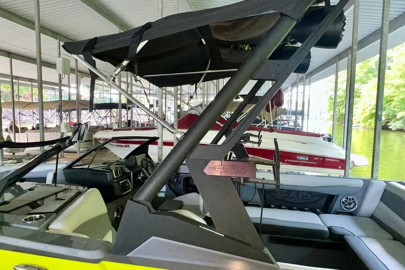 Slide: The Image of 2023 Axis A225 boat docked in a marina, featuring sleek design and modern interior. - 28