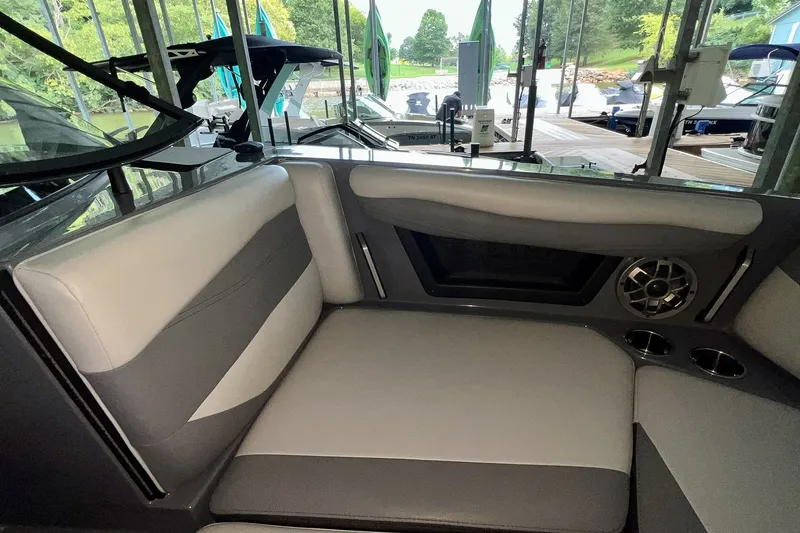 Slide: The Image of Interior of a 2023 Axis A225 boat with gray seating and speaker system. - 23