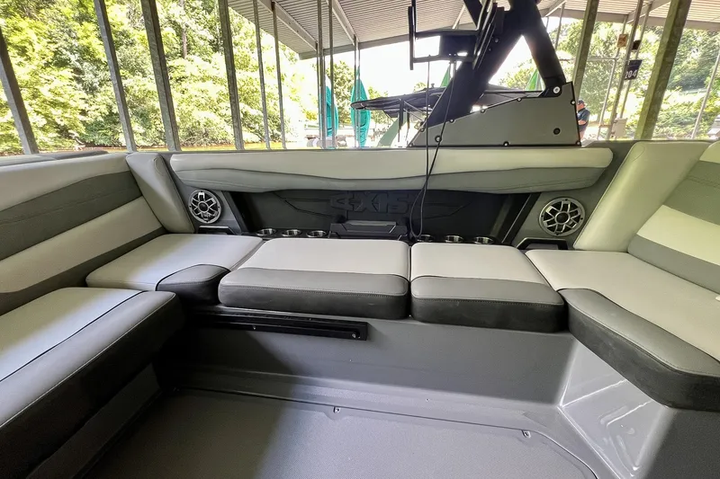Slide: The Image of 2023 Axis A225 boat interior with cushioned seating and built-in speakers. - 12