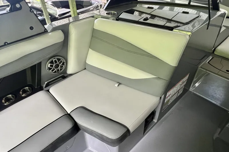 Slide: The Image of 2023 Axis A225 boat interior with cushioned seating and built-in speaker. - 19