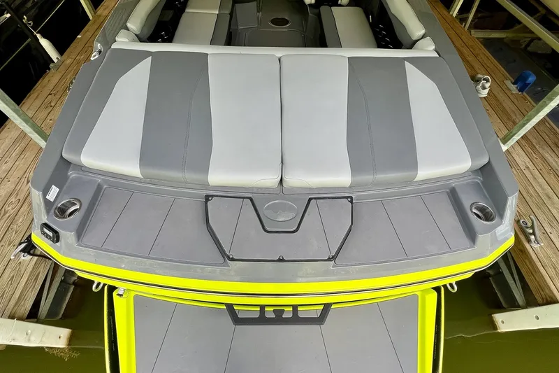 Slide: The Image of 2023 Axis A225 boat with gray and white seating, docked on wooden platform. - 8