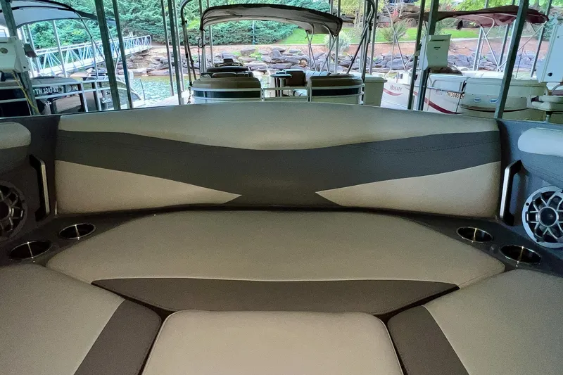 Slide: The Image of Interior of 2023 Axis A225 boat with cushioned seating and cup holders. - 25