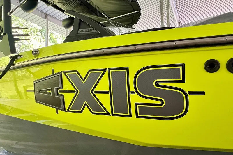 Slide: The Image of 2023 Axis A225 boat with bold logo on bright yellow hull. - 32