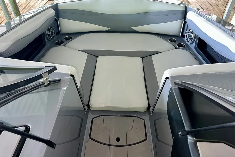 Slide: The Image of 2023 Axis A225 boat interior with cushioned seating and cup holders. - 21