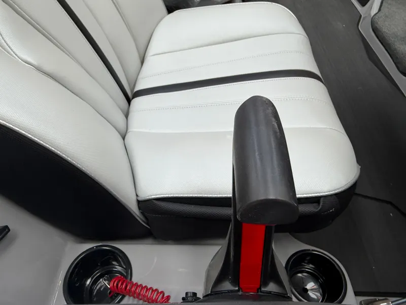 Slide: The Image of Close-up of a white seat with black stripes and a black armrest in a boat. - 16