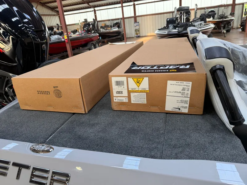 Slide: The Image of Two boxes are placed on the deck of a Skeeter boat in a storage facility. - 17